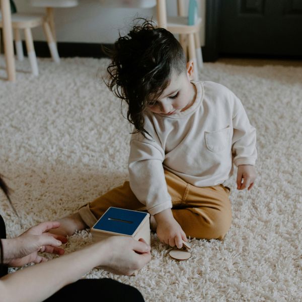How can a piggy bank help teach children about money?